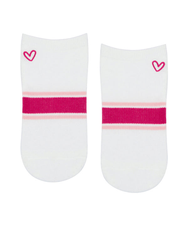 Classic low rise grip socks featuring playful pink stripes for style and comfort during workouts and everyday wear