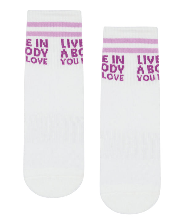 A pair of lilac crew non slip grip socks with a stylish Self Love design